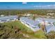 Aerial view of townhouses with metal roofs, and spacious grassy areas at 3923 Cape Haze Dr # 306, Rotonda West, FL 33947