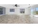 Bright living room with tile floors, ceiling fan, and sliding glass doors to balcony at 3923 Cape Haze Dr # 306, Rotonda West, FL 33947