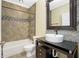 Clean bathroom with tile shower/tub combo and updated vanity at 3923 Cape Haze Dr # 306, Rotonda West, FL 33947