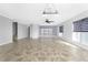 Sunlit living room with tile floors, ceiling fan, and access to stairs at 3923 Cape Haze Dr # 306, Rotonda West, FL 33947