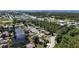 Aerial view of a home nestled in a community near a lake and other amenities at 404 Cypress Forest Dr, Englewood, FL 34223