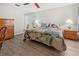 Spacious bedroom with a large bed, wood furniture, and ceiling fan at 404 Cypress Forest Dr, Englewood, FL 34223