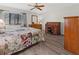 Main bedroom with wood dresser, desk, and ceiling fan at 404 Cypress Forest Dr, Englewood, FL 34223