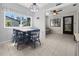 Cozy breakfast nook with four chairs and access to the back patio at 404 Cypress Forest Dr, Englewood, FL 34223