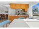 Kitchen features a dining area with seating for four and a view of the living room at 404 Cypress Forest Dr, Englewood, FL 34223