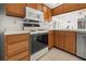 Bright kitchen features wood cabinets, updated appliances, and ample counter space at 404 Cypress Forest Dr, Englewood, FL 34223