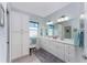 Bright bathroom with a dual sink vanity, ample storage, and modern lighting at 552 Box Elder Ct, Englewood, FL 34223