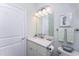 Well-lit bathroom with a single sink vanity, neutral finishes, and a toilet at 552 Box Elder Ct, Englewood, FL 34223