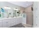 Bathroom with double vanity, modern fixtures, and a glass-enclosed shower at 552 Box Elder Ct, Englewood, FL 34223