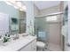 Beautiful bathroom featuring a glass-enclosed shower, a single sink vanity, and tile flooring at 552 Box Elder Ct, Englewood, FL 34223