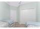 Cozy bedroom featuring two twin beds, a closet, and a neutral color scheme at 552 Box Elder Ct, Englewood, FL 34223