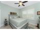 Comfortable bedroom with a queen-sized bed, a ceiling fan, and a window with shutters at 552 Box Elder Ct, Englewood, FL 34223