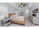 Comfortable bedroom with tray ceiling, shuttered windows, and neutral decor at 552 Box Elder Ct, Englewood, FL 34223