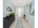 Bright foyer with decorative wall art, a console table, and a view of the elegant front door at 552 Box Elder Ct, Englewood, FL 34223
