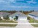 Charming single-story home with a manicured lawn, paver driveway, and an attached two-car garage at 552 Box Elder Ct, Englewood, FL 34223