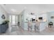 Open-concept kitchen with white cabinetry, breakfast bar, and views of the dining and foyer areas at 552 Box Elder Ct, Englewood, FL 34223