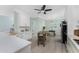 Bright kitchen with white cabinets, marble backsplash, stainless steel appliances and adjacent eat in dining area at 552 Box Elder Ct, Englewood, FL 34223