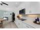 Modern kitchen featuring stainless appliances, white cabinets, and sleek countertops, with an adjacent breakfast nook at 552 Box Elder Ct, Englewood, FL 34223