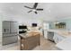 Open-concept kitchen featuring white cabinets, stainless appliances, a center island, and a breakfast nook at 552 Box Elder Ct, Englewood, FL 34223