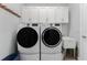 Practical laundry room with modern washer and dryer, cabinets, and utility sink at 552 Box Elder Ct, Englewood, FL 34223