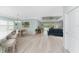 Open-concept living space with bar seating, dining area, and comfortable seating overlooking the pool at 552 Box Elder Ct, Englewood, FL 34223