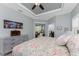 Main bedroom featuring a tray ceiling, cityscape art, and access to a private office at 552 Box Elder Ct, Englewood, FL 34223
