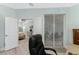 View from the office into the main bedroom showing an open floor plan and patio access at 552 Box Elder Ct, Englewood, FL 34223