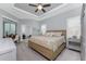 Spacious main bedroom with tray ceiling and connected office space flooded with natural light at 552 Box Elder Ct, Englewood, FL 34223
