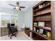 Dedicated home office with built-in shelving and plantation shutters for natural light at 552 Box Elder Ct, Englewood, FL 34223