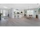 Spacious open-concept living area with a modern kitchen, dining space, and inviting foyer at 552 Box Elder Ct, Englewood, FL 34223
