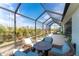 Cozy screened-in patio with comfortable seating, perfect for enjoying the outdoors at 552 Box Elder Ct, Englewood, FL 34223