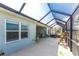 Spacious screened lanai offering a comfortable seating area and outdoor kitchen at 552 Box Elder Ct, Englewood, FL 34223