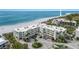 Aerial view of beachfront condo complex with ocean and lush landscape at 5700 Gulf Shores Dr # C157, Boca Grande, FL 33921