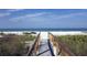 Wooden walkway to the beach with ocean views at 5700 Gulf Shores Dr # C157, Boca Grande, FL 33921