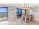 Coastal-style dining area with ocean view and seating for six at 5700 Gulf Shores Dr # C157, Boca Grande, FL 33921
