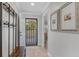 Bright entryway with coat rack, bench, and view to the living area at 5700 Gulf Shores Dr # C157, Boca Grande, FL 33921