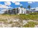 Exterior view of the condo building near beach at 5700 Gulf Shores Dr # C157, Boca Grande, FL 33921