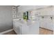 Modern white kitchen with island, updated appliances, and ocean view at 5700 Gulf Shores Dr # C157, Boca Grande, FL 33921