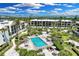 Aerial view of condo complex with inviting pool at 5700 Gulf Shores Dr # C157, Boca Grande, FL 33921