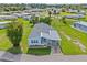 Inviting aerial view of a light blue home featuring a carport in a quiet neighborhood at 5704 Holiday Park Blvd, North Port, FL 34287