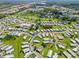 Expansive aerial view showcasing a well-maintained community with lush green spaces at 5704 Holiday Park Blvd, North Port, FL 34287