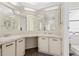 Bright bathroom featuring double sinks, a spacious counter, and ample lighting at 5704 Holiday Park Blvd, North Port, FL 34287