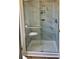 Modern bathroom features a glass-enclosed shower with marble tiling and a built-in shelf at 5704 Holiday Park Blvd, North Port, FL 34287