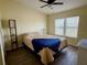 Bedroom featuring wood floors, neutral walls, and a large window at 5704 Holiday Park Blvd, North Port, FL 34287