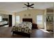 Bright bedroom with hardwood floors, closet, and a view of the bathroom mirror at 5704 Holiday Park Blvd, North Port, FL 34287