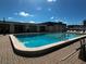 Inviting community pool with brick patio and well-kept surroundings at 5704 Holiday Park Blvd, North Port, FL 34287