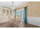 Dining area with white cabinets, hardwood floors, and a view of the outdoors at 5704 Holiday Park Blvd, North Port, FL 34287