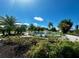 Beautiful fountain surrounded by lush tropical landscaping on a bright, sunny day at 5704 Holiday Park Blvd, North Port, FL 34287
