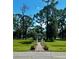 Charming gazebo surrounded by towering trees and green lawns at 5704 Holiday Park Blvd, North Port, FL 34287