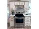 Functional kitchen with stainless steel range and neutral cabinets, offering a practical space for cooking and meal preparation at 5704 Holiday Park Blvd, North Port, FL 34287